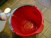 filling a bucket with vinegar