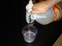 pouring vinegar with water