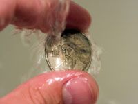 coins under running water