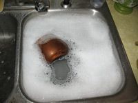 copper kettle in soapy water