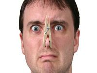 Person with clothespin on their nose