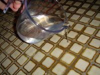 pouring solution on grout