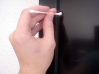 cotton swab in the screen edges