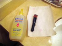 baby shampoo and makeup brush on paper towel