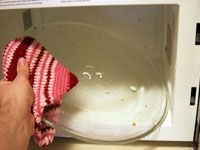 scrubbing the microwave tray