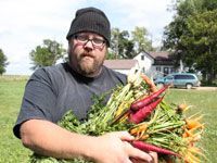 guy with lots of vegetables in his arms