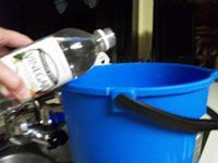 putting vinegar in bucket
