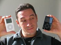 Guy between a white and black ipod