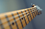 Close up of a guitar fret board