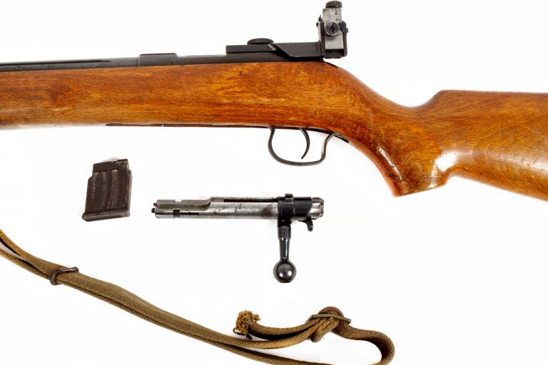A bolt action rifle on a white background.